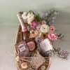 A celebration box with bubbly, chocolate, fresh flowers and a Liberty x