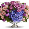Purple tulips, blue hydrangea, lavender and pink roses are mixed with delicate