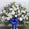 Beautiful arrangement of blue delphinium; white roses, snapdragons, cremones, carnations, daisy poms