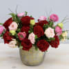 A breathtaking floral arrangement crafted with a delicate fusion of roses, ranunculus