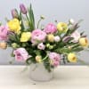 A melody of buttercup (ranunculus) flowers in pastels along with tulips and