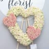 Three hearts in one, all containing red roses. The two smaller hearts