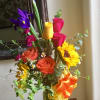 Bright bouquet filled with sunflowers, brightly colored roses and irises!  One