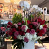 This combination of roses, pink and white bell of Ireland orchid plants