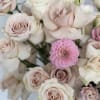 A chic vase adorned with an elegant arrangement of pink dahlias and