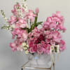 A chic vase adorned with an stunning arrangement of pink roses. The