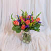 Featuring vibrant hot pink and orange roses that symbolize joy and passion