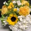 A cheerful garden mix of seasonal Yellow and White blossoms. Designed low