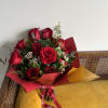 Red roses in a waterproof wrap. Ties with ribbon.

