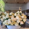 White and beige roses beautifully arranged in a gray vase, offering a