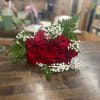 1 Dozen red roses wrapped with greens and filler. 

Roses will arrive