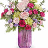 This bouquet showcases light pink roses, hot pink spray roses, green carnations