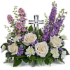 This beautiful piece includes cr&egrave;me roses, lavender larkspur, lavender montecasino asters, white