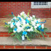 Nice and beautiful casket spray with roses and orchids and snapdragons and