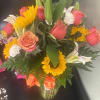 A boho arrangement featuring an eclectic mix of flowers and textures, this