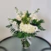 Beautiful arrangement with hydrangeas, stocks and white roses with green hypericum, solidago