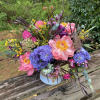 Cascade of full and fragrant flowers in an arrangement. Accented with texture