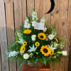 White roses, sunflowers, lilies, snapdragons, stock, and yellow daisies accented with yellow