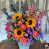 A colorful reminder that brighter days are ahead, this uplifting arrangement of