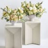 A lush and whimsical garden-style floral arrangement in a vase, brimming with
