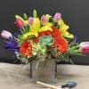   Sending this cute arrangement reminds your recipient of spring is