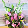 A peaceful arrangement of  Pink Roses, Lilies,Snapdragons...flowers and color may vary