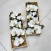 A sophisticated arrangement featuring six pristine white orchids &mdash;perfect for prom, homecoming