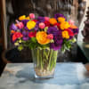 Premium Roses, Lisianthus, Tulips, Ranunculus, and more in glass vase and white