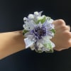 blue cushion daisies with variegated pit, babies breath and iridescent ribbon. When