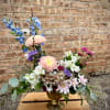 A stunning arrangement in a metal chalise-shaped container. A lovely mix of