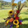 This striking fresh arrangement features the gorgeous jewel tone colors of fall.