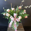 A vase of 10 tulips arranged with filler &amp; greens.
