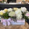 White and soft yellow roses with a variety of greenery and eucalyptus