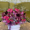 Roses, Spray Roses, Orchids in a ceramic vase. 