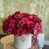 A lavish collection of rich pink and deep burgundy roses arranged in