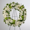 A beautiful white and green tribute wreath that calms, this easel arrangement