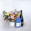 This gift package begins with a beautiful arrangments of colorful blooms. Then