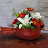 Artificial red and white flowers in a Cardinal planter