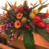 This Tropical casket saddle  Is full of seasonal exotic blooms a