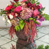 A beautiful, elegant arrangement all in blush pink and red tones. 
Designed