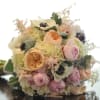 A BED OF WHITE HYDRANGEA TOPPED OFF WITH PEACH GARDEN ROSES, PALE