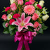 A burst of elegance and color! This stunning bouquet featuring lilies, roses
