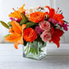 Orange asiatic lilies, hot pink and light orange roses, miniature red carnations