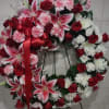 This beautiful wreath is a soothing mix of red and white roses