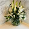 Glass basket filled with long lasting alstroemeria and lilies for the holiday.