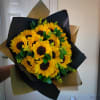 This stunning bouquet features vibrant yellow sunflowers with rich brown centers, symbolizing