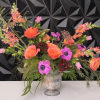 Modern floral arrangement in an elegant Chelsea, antiqued glass vase. 