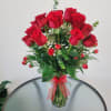 Beautiful arrangement of 36 red roses, eucalyptus, baby breath and spray red