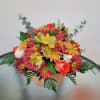 Beautiful arrangement on a pumpkin base with cushion pompon, daisy pompon, roses