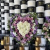 Spring time color florals in a full heart, easel stand included.